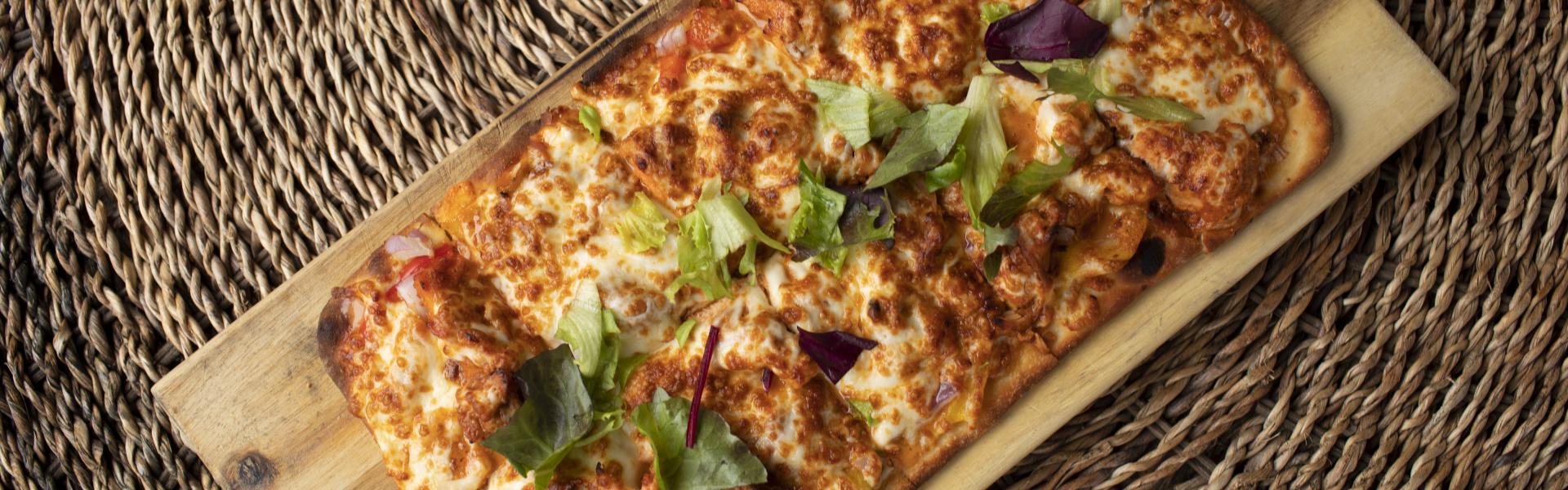 Flatbread pizza on serving board