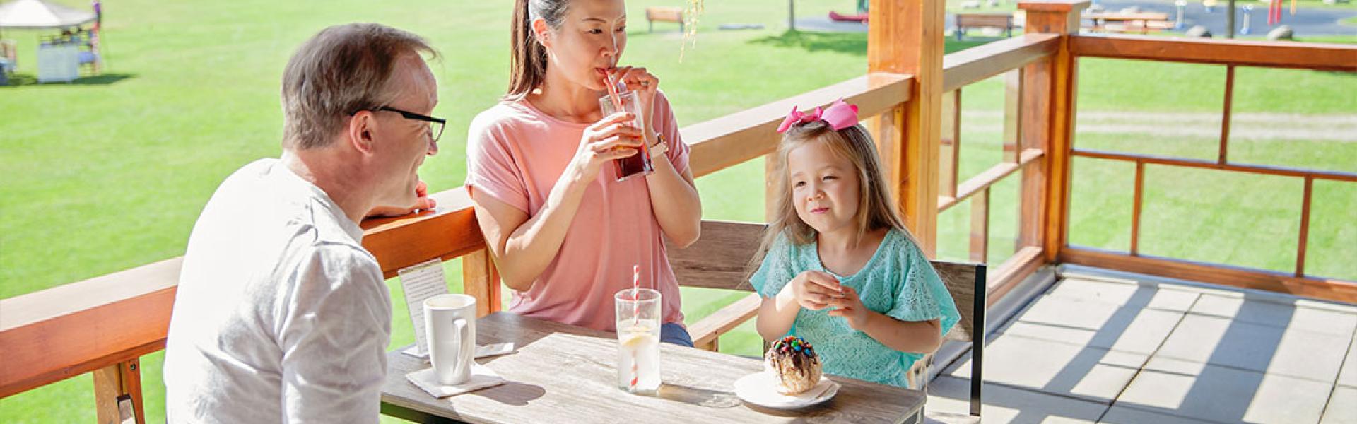 Family dining on a patio in LeBourdais Park