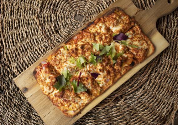 Flatbread pizza on serving board