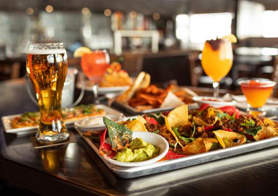 Nachos with guacamole, Pizza and Fries A glass of Beer , juice