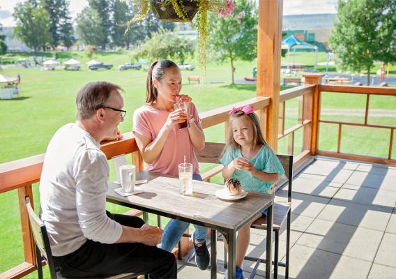 Family dining on a patio in LeBourdais Park